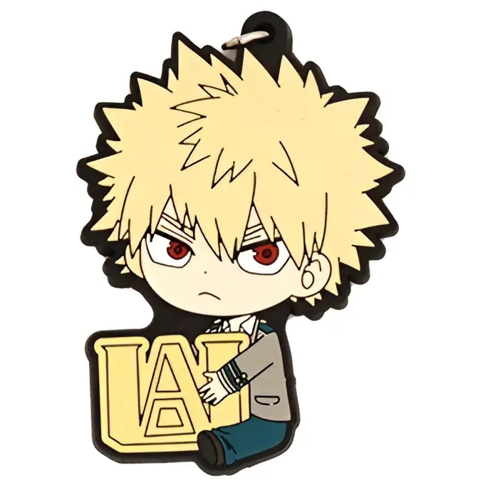 Yellow spiky-haired deku rubber keychain from hero academia with red eyes holding a gold u.a. emblem in pvc material