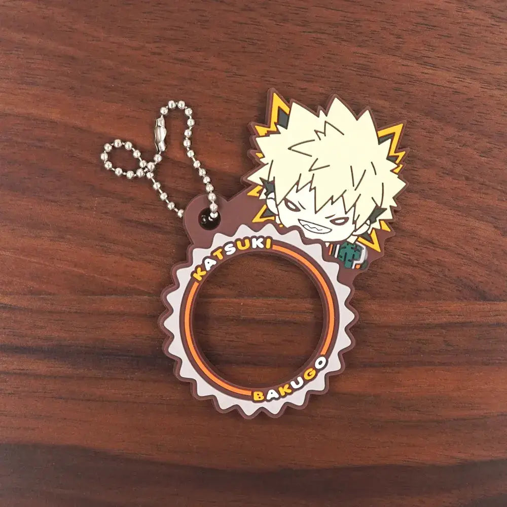 Brown and orange gear-shaped rubber keychain featuring chibi bakugo with spiky hair and lightning bolts from hero academia