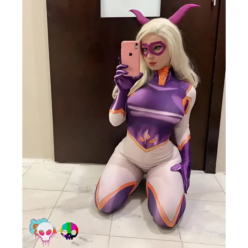 A cosplayer wearing a hero academia mt lady cosplay jumpsuit in purple holding a pink iphone 12 pro max