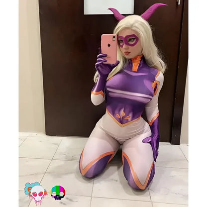 A cosplayer wearing a hero academia mt lady cosplay jumpsuit in purple holding a pink iphone 12 pro max