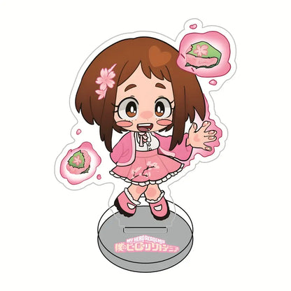 Pink and white chibi-style acrylic standee of hero academia sakura girl with brown hair in pink dress surrounded by cherry blossom sweets