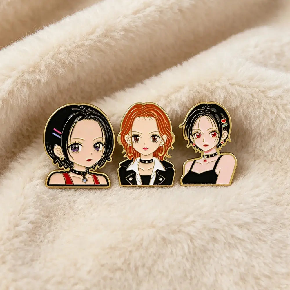 Three anime-style enamel lapel pins featuring nana oosaki enamel design with gold-trimmed edges and vibrant colors