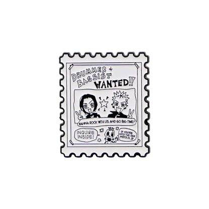 Black and white nana oosaki enamel lapel pin shaped like a postage stamp with drummer and bassist wanted text