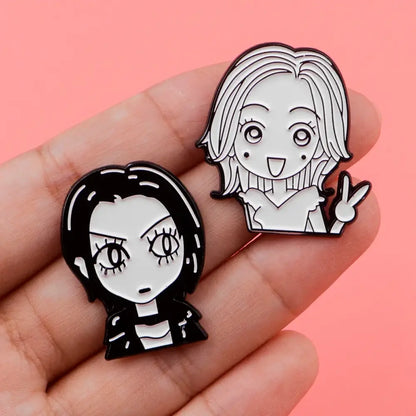 Two black-and-white cartoon-style nana oosaki enamel lapel pins featuring characters with dark and blonde hair peace sign