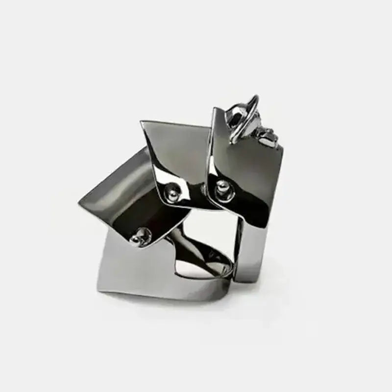 Nana oosaki knuckle ring in polished chrome metal armor with a bold style and angular geometric design