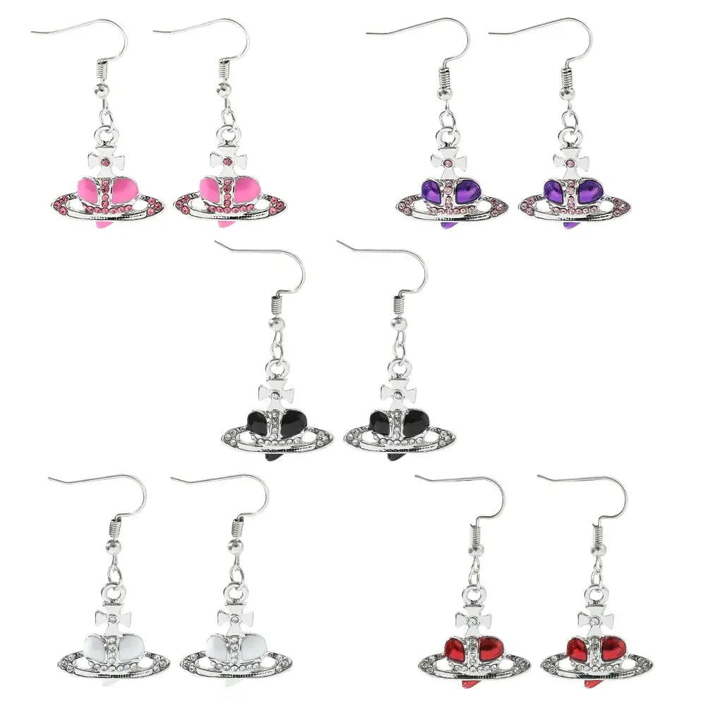 Silver plated saturn planet earrings with colorful pink purple black white and red cz heart charms by nana oosaki