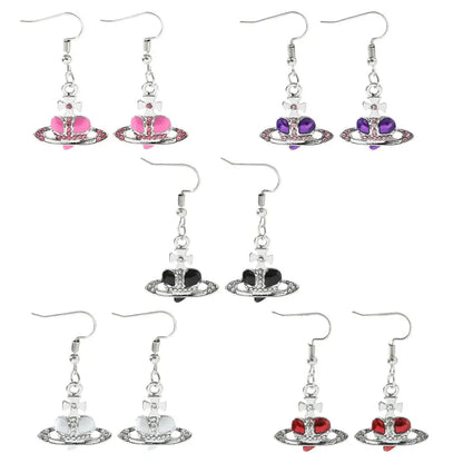 Silver plated saturn planet earrings with colorful pink purple black white and red cz heart charms by nana oosaki