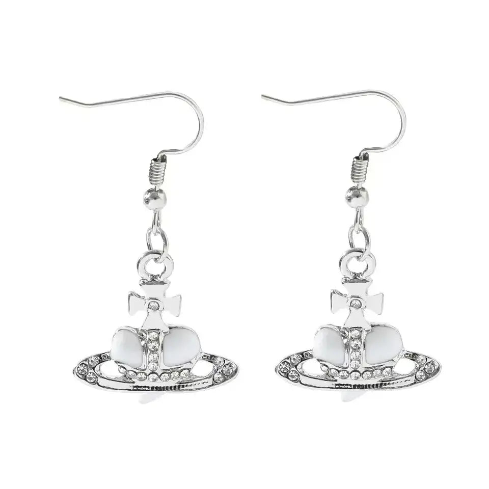 Silver-plated nana oosaki saturn planet earrings with vivienne westwood orb, white enamel, crystal embellishments, and cross motif