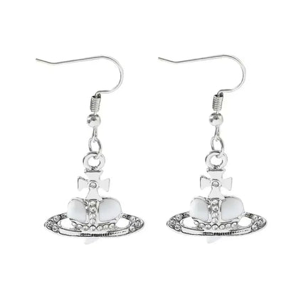 Silver-plated nana oosaki saturn planet earrings with vivienne westwood orb, white enamel, crystal embellishments, and cross motif