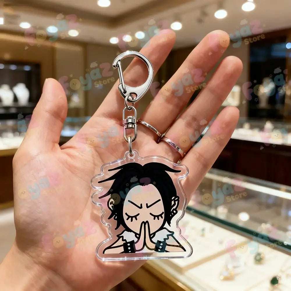 Clear acrylic nana osaki keychain featuring cartoon character in prayer pose with silver clasp bag charm accessory