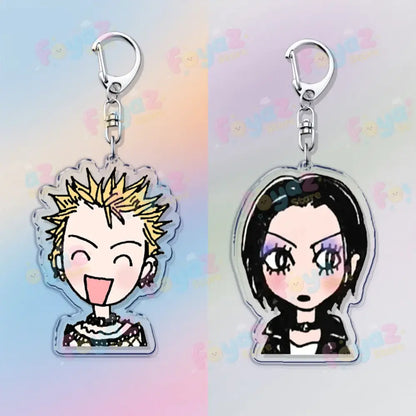 Two clear acrylic nana osaki keychains with silver clasps featuring cartoon portraits as bag charms