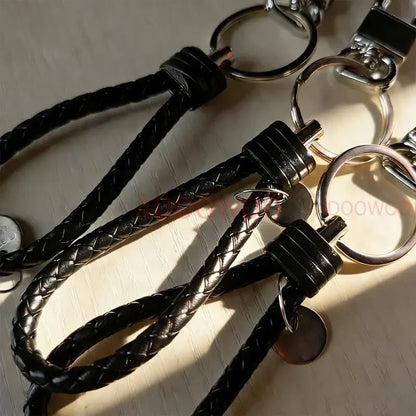 Black braided leather keychain with silver metal ring and clasp featuring naruto akatsuki red cloud design
