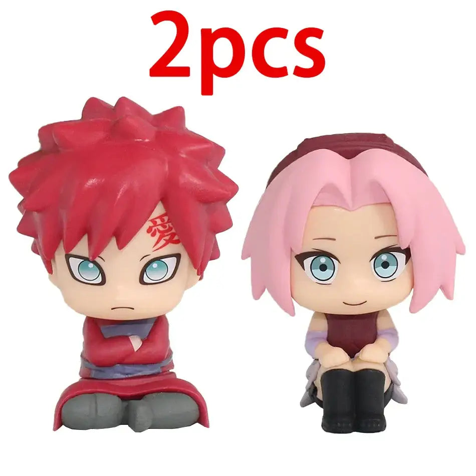 Chibi-style naruto with red spiky hair and sakura with pink bob hair glossy plastic figurines car decoration opp bag
