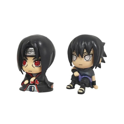 Two chibi-style naruto kakashi anime figure figurines in dark cloaks with red eyes and purple pants pvc collectible model
