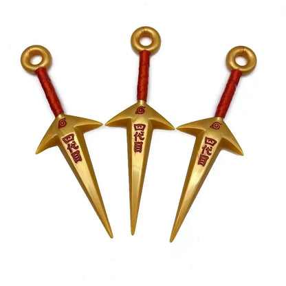 Golden plastic kunai model with red textured handles and engraved japanese characters made of durable pvc