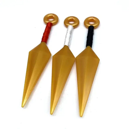Three golden pvc kunai model knives with red silver and black textured handles for naruto cosplay or collection