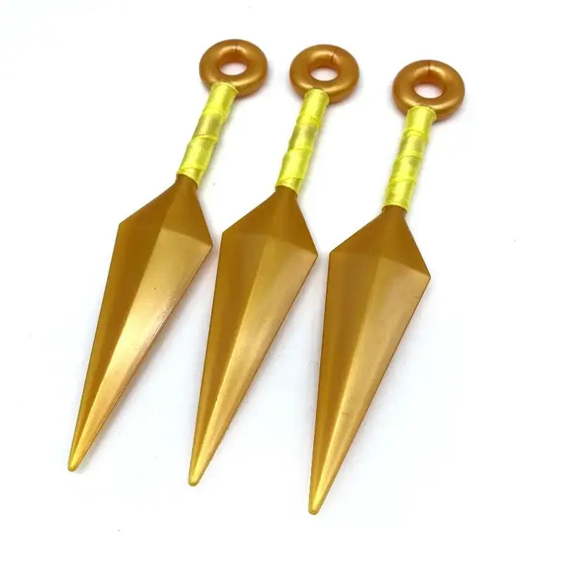 Three golden pvc kunai model knives with yellow textured handles and circular loops for naruto fans