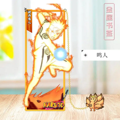 Golden metallic naruto metal bookmark with fiery orange and yellow design featuring chakra sphere and nine-tails fox base