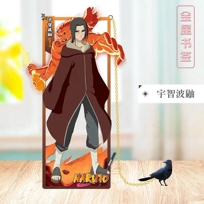A sleek transparent acrylic sasuke uchiha stand with fiery orange background and gold chain from naruto metal bookmark