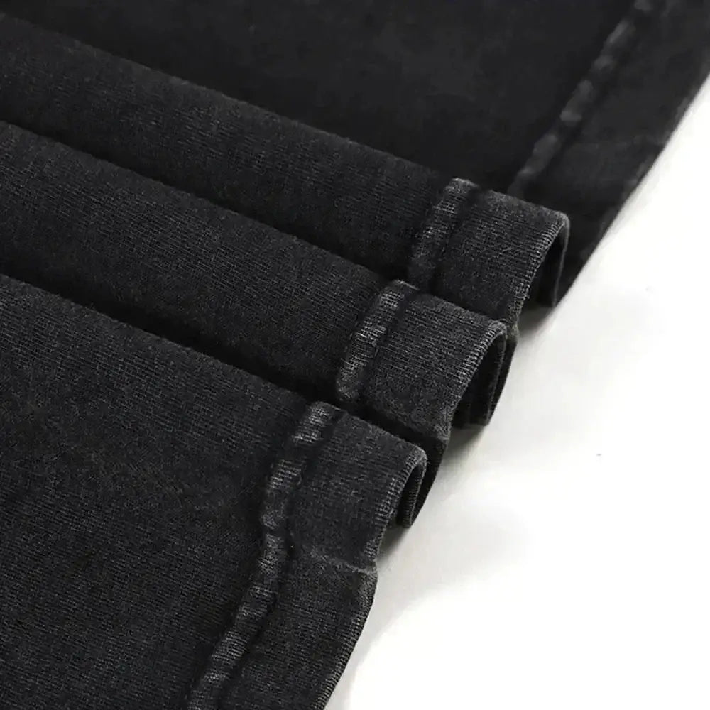 Black denim fabric with worn texture and visible stitching along rolled cuffs in naruto minato namikaze oversized tee