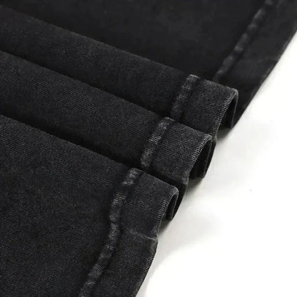 Black denim fabric with worn texture and visible stitching along rolled cuffs in naruto minato namikaze oversized tee
