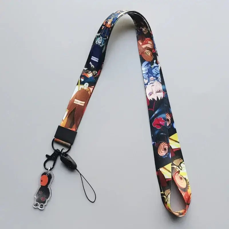 Colorful naruto phone strap lanyard with cute cartoon anime characters on dark fabric and black plastic hardware with charm