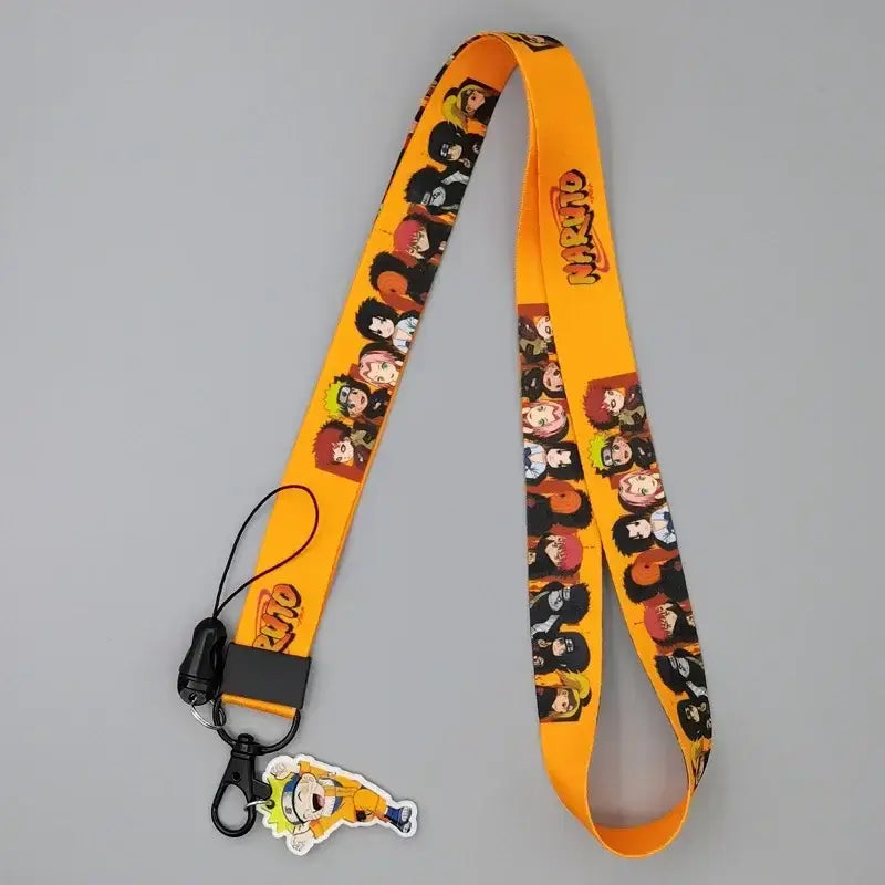 Bright orange naruto phone strap lanyard with cute cartoon chibi characters and black clip with charm attached