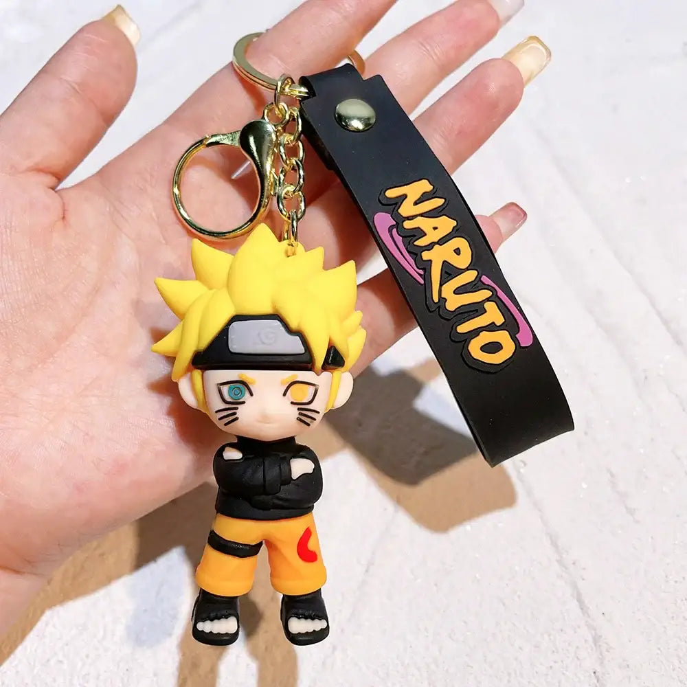 Yellow spiky-haired naruto pvc silicone keychain with black orange outfit attached to a black wrist strap with naruto logo