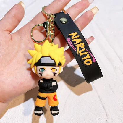 Yellow spiky-haired naruto pvc silicone keychain with black orange outfit attached to a black wrist strap with naruto logo