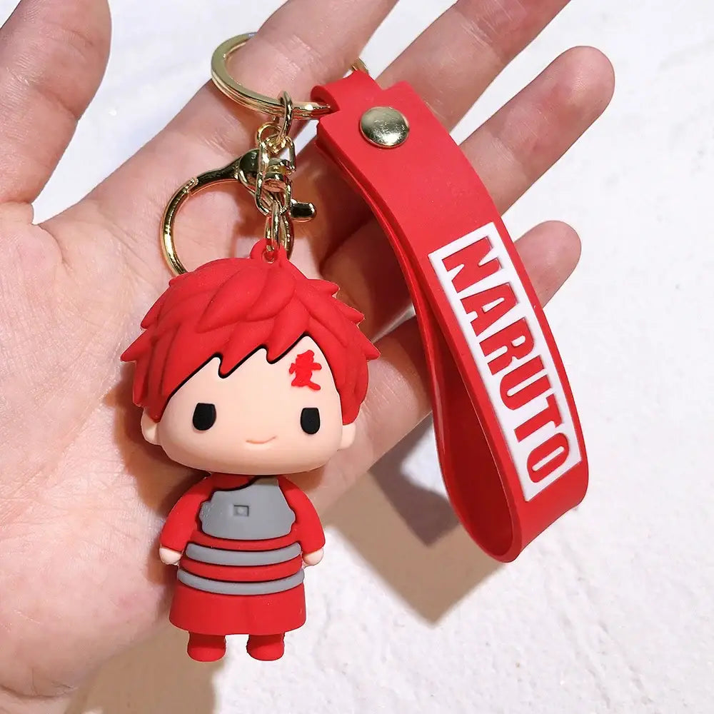 Red pvc silicone keychain featuring chibi naruto with spiky red hair and gray-striped outfit on red wrist strap