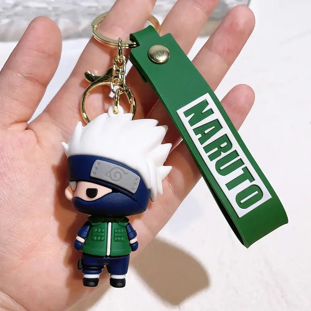 Green and white naruto pvc silicone keychain featuring chibi spiky white hair figure with blue headband and green vest