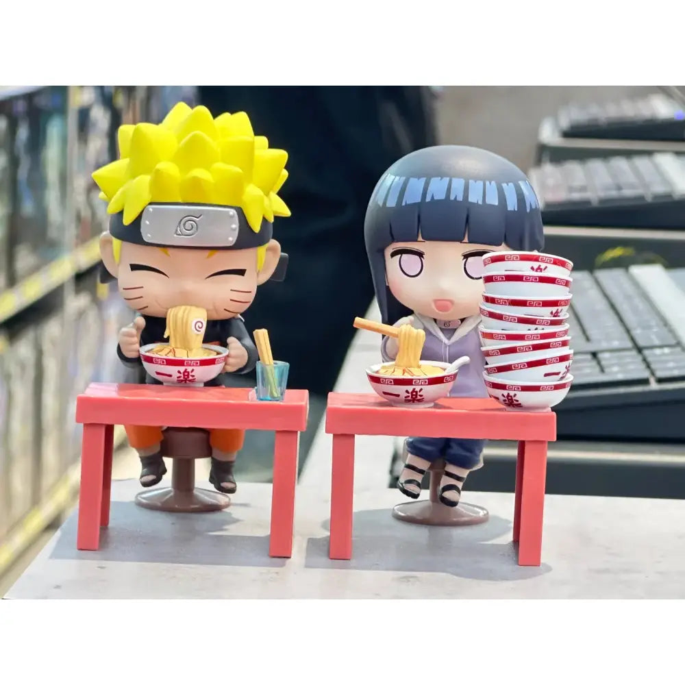 Naruto and hinata handmade ornament blind box figurines seated at pink tables holding ramen bowls with chopsticks