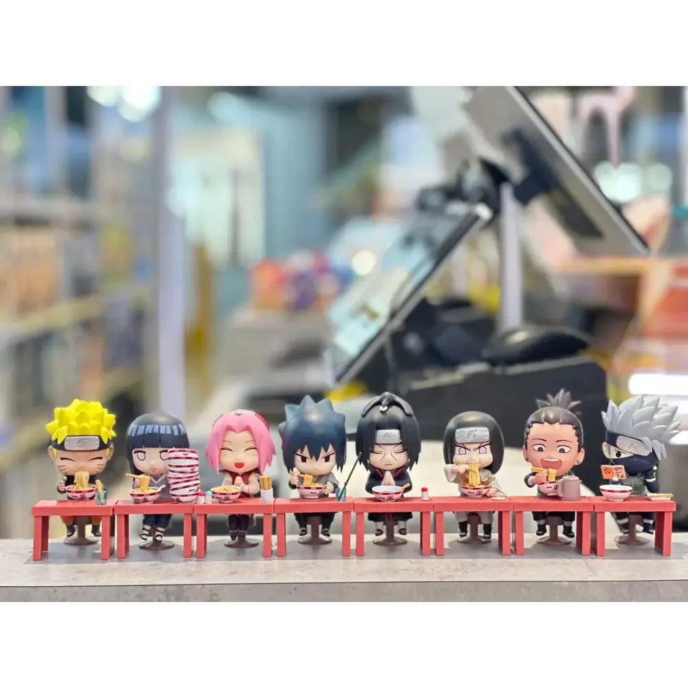 A row of eight chibi-style naruto blind box handmade ornaments eating ramen at a red table with distinct hairstyles