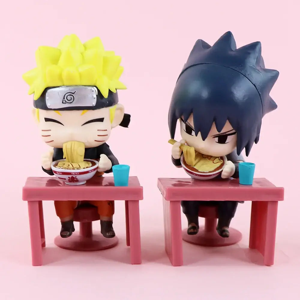 Chibi-style naruto and sasuke blind box figures seated at pink plastic table with ramen bowls for desktop display