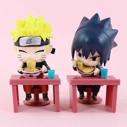 Chibi-style naruto and sasuke blind box figures seated at pink plastic table with ramen bowls for desktop display