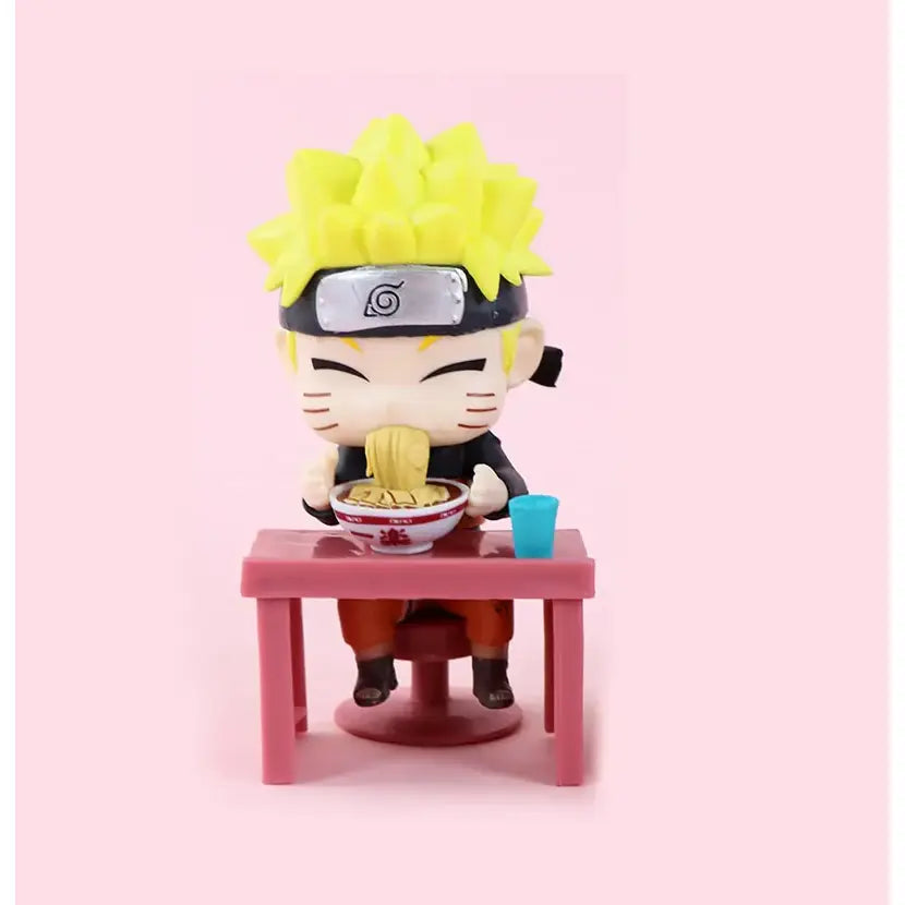 Chibi-style Naruto figure with spiky yellow hair seated at pink table eating noodles from white bowl in Naruto Sasuke set