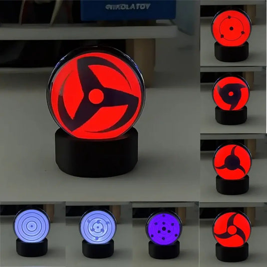 Red and black glowing sharingan led crystal lamp with music rhythm sync feature encased in clear glass with black base