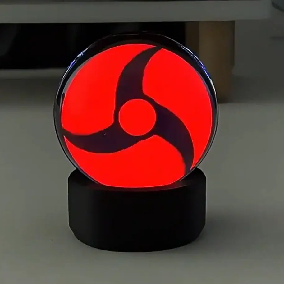 Naruto Sasuke Sharingan led crystal night light with red glowing sphere and black base encased in clear glass