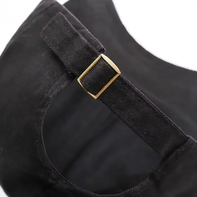 Black denim strap with a gold toned rectangular buckle on the back of a naruto shinobi snapback cap adjustable fit