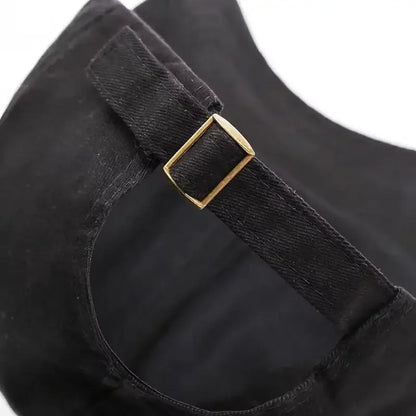 Black denim strap with a gold toned rectangular buckle on the back of a naruto shinobi snapback cap adjustable fit