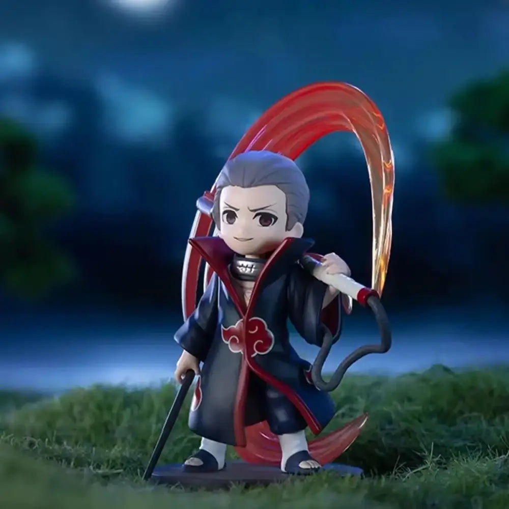 Chibi-style naruto shippuden akatsuki blind box figure in black and red cloak holding staff with glowing orange weapon