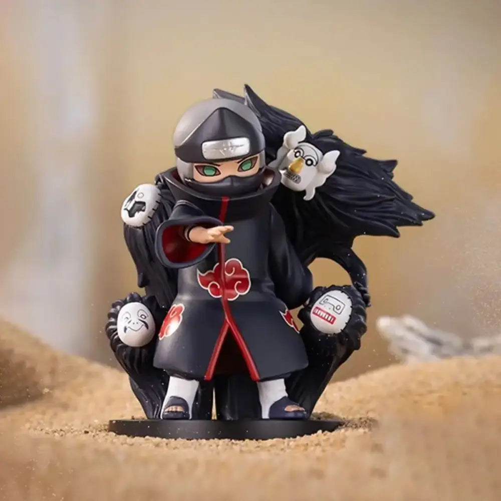 Naruto Shippuden akatsuki blind box figurine in black and red holding white masked figures with a silver headband