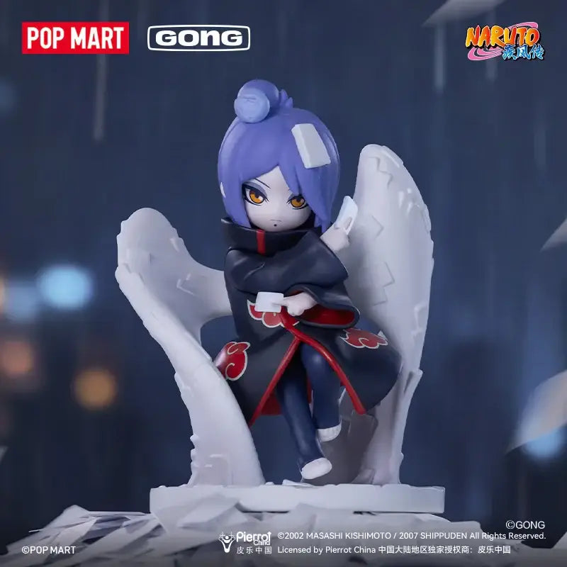 A detailed naruto shippuden akatsuki blind box figure with vibrant purple hair and red cloud black cloak seated on white wings