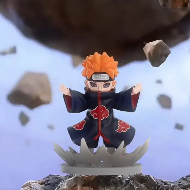 Orange-haired anime figurine in dark blue cloak with red clouds and forehead protector from naruto shippuden blind box