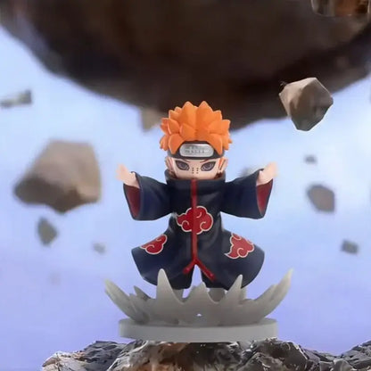 Orange-haired anime figurine in dark blue cloak with red clouds and forehead protector from naruto shippuden blind box