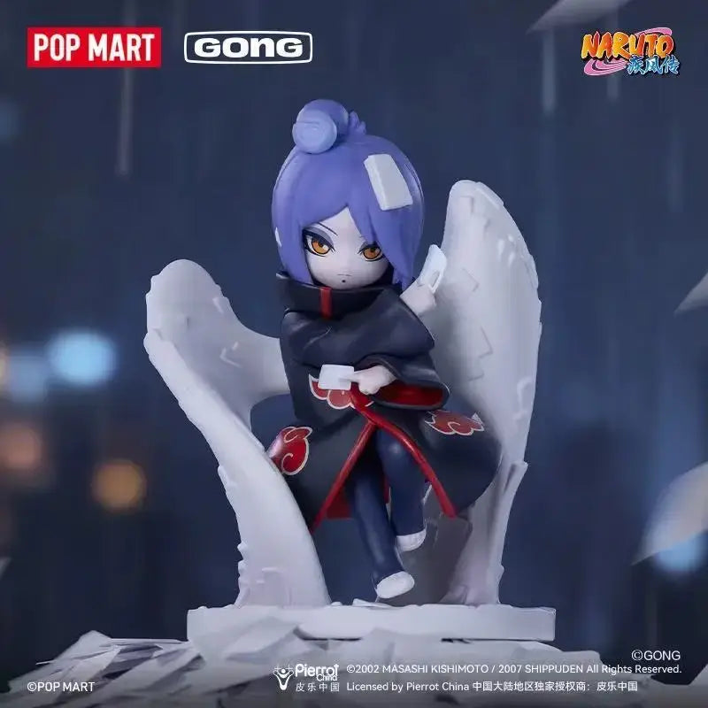 Purple-haired naruto shippuden akatsuki blind box mystery figure in black red cloak with white wings on cracked base