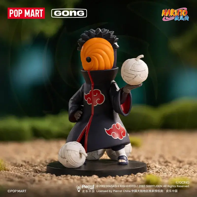 Orange-masked naruto shippuden akatsuki blind box figure in black cloak holding white ball on circular base