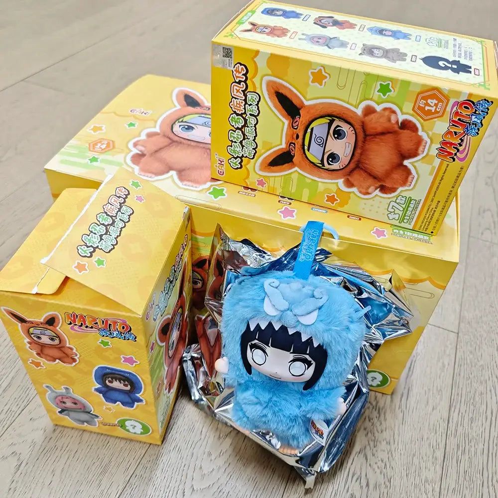 Blue fluffy plush keychain featuring a naruto shippuden cartoon character with black hair and white eyes in opp bag blind box
