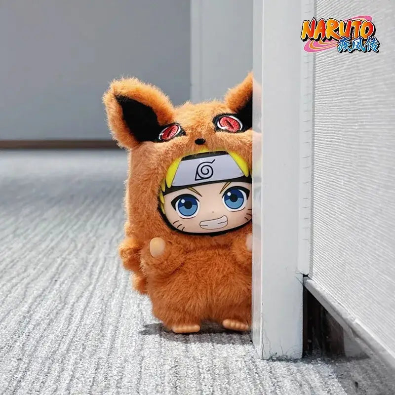Plush toy of naruto shippuden in tan furry fox costume with black ears and red eyes from blind box opp bag collection