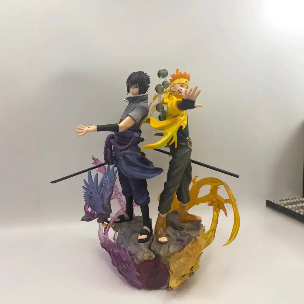 Naruto shippuden sasuke pvc statue featuring vibrant orange and dark blue costumes with detailed sculpting in dynamic poses